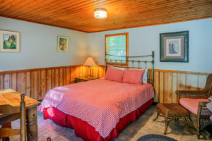 Hitching-Post-Cabin-–-checkered-bedding-and-chair-300x200.jpg